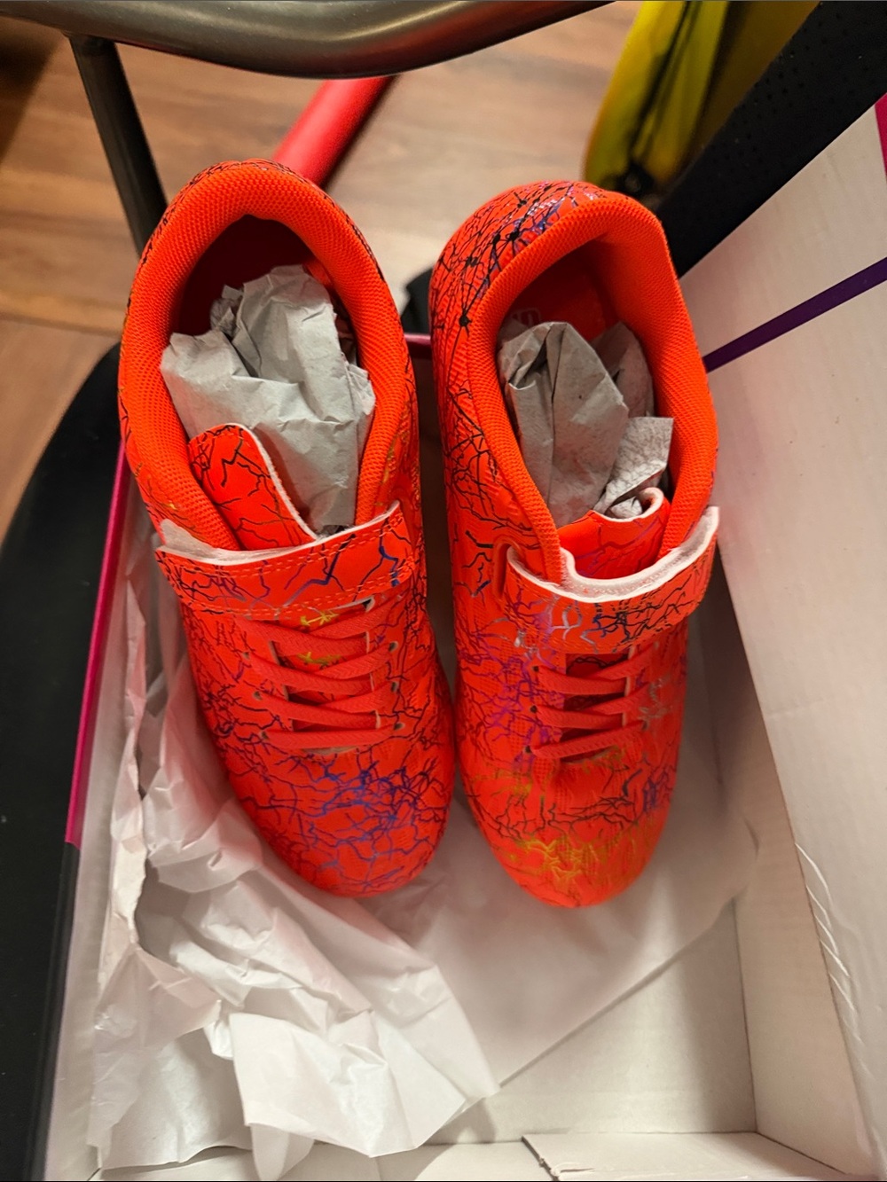 Kids Bright Orange Athletic soccer cleats with Multicolor Splatter